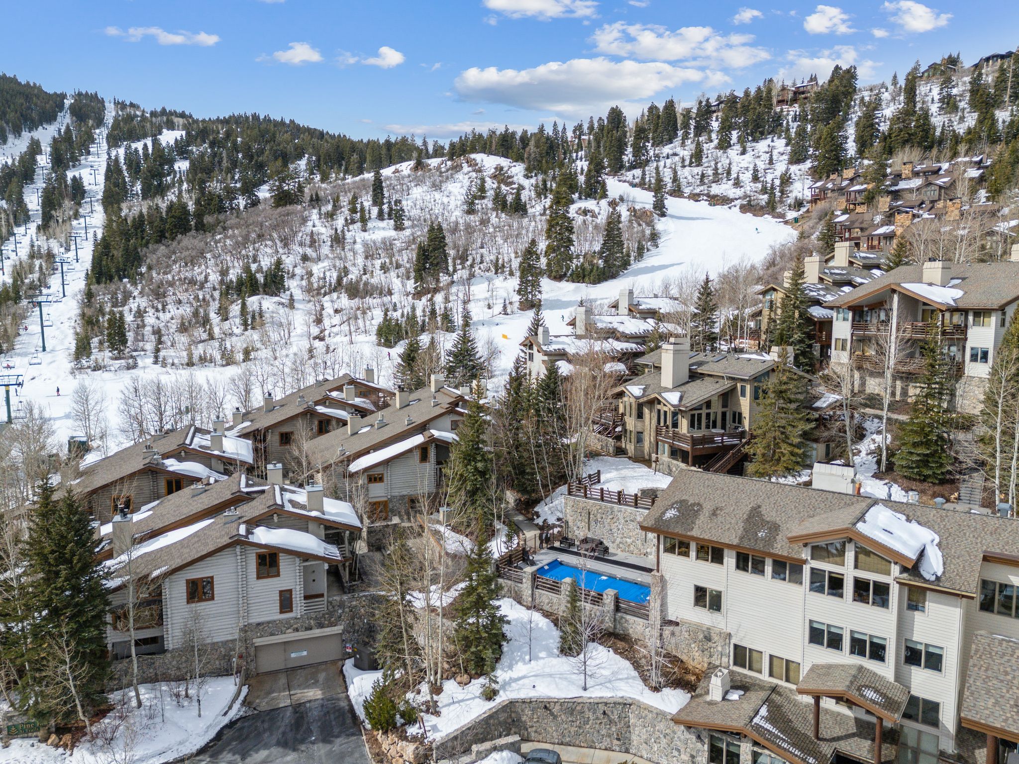 Snowy aerial view featuring a mountain view and a residential view