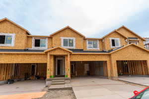 View of front of property with a garage and concrete driveway