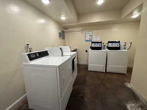 Shared laundry area with washer and clothes dryer and baseboards