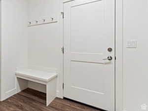 Mudroom featuring dark wood-style floors and baseboards