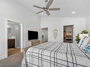 Bedroom with a spacious closet, baseboards, lofted ceiling, carpet floors, and recessed lighting