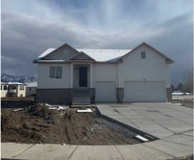 Ranch-style house with concrete driveway and an attached garage