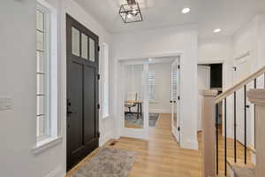 Entrance foyer featuring visible vents, baseboards, light wood-type flooring, recessed lighting, and french doors