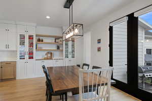 Dining space with recessed lighting and light wood-type flooring