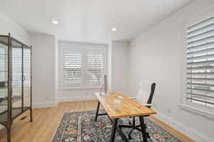 Office space with recessed lighting, baseboards, and light wood finished floors
