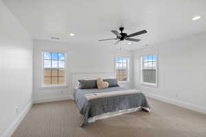 Carpeted bedroom featuring recessed lighting, visible vents, baseboards, and ceiling fan