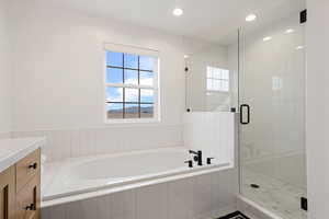 Bathroom featuring vanity, a garden tub, recessed lighting, and a stall shower
