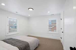Bedroom with recessed lighting, visible vents, carpet flooring, and baseboards