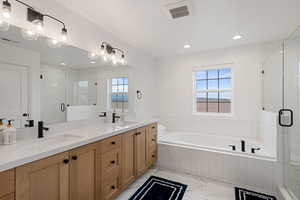 Full bathroom with a bath, visible vents, and a sink