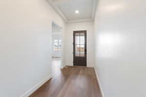 Entryway with recessed lighting, wood finished floors, and baseboards
