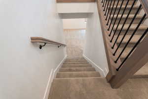 Stairway featuring carpet flooring and baseboards