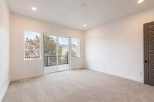Unfurnished room with light carpet, visible vents, recessed lighting, and baseboards