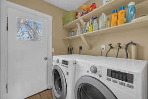 Laundry area with tile patterned flooring, laundry area, and washer and clothes dryer