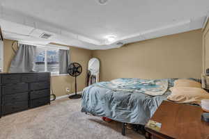 Bedroom featuring visible vents, baseboards, carpet, and a textured ceiling