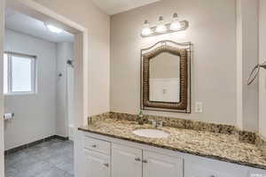 Bathroom featuring vanity and baseboards