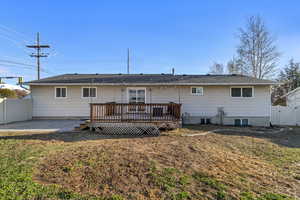 Back of house showing yard, patio and deck.