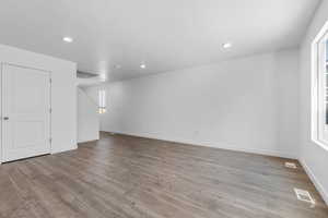 Spare room with recessed lighting, visible vents, and wood finished floors