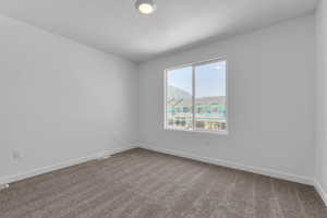 Unfurnished room with baseboards, carpet floors, a textured ceiling, and visible vents