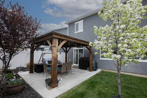 View of patio featuring fence and a gazebo