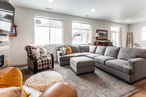 Living room featuring recessed lighting, visible vents, baseboards, and a fireplace