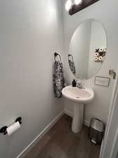 Bathroom featuring wood finished floors and baseboards