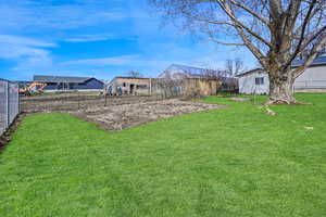 View of yard featuring fence