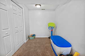 Game room with baseboards, visible vents, and carpet
