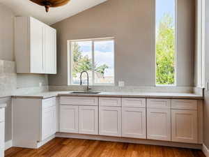 Kitchen with white cabinetry, Range and hood has since been installed