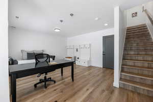 Office space featuring visible vents, baseboards, and wood finished floors