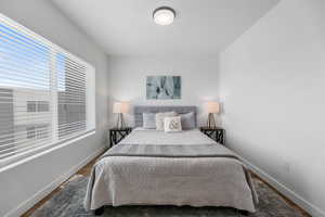 Bedroom with baseboards and wood finished floors