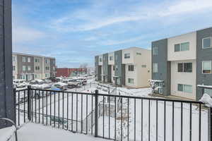 View of snow covered back of property