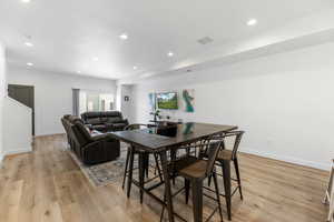 Dining room featuring light wood-type flooring, visible vents, and recessed lighting