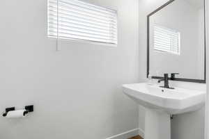 Bathroom with baseboards and a sink