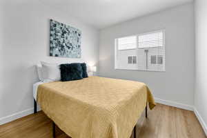 Bedroom featuring baseboards and wood finished floors