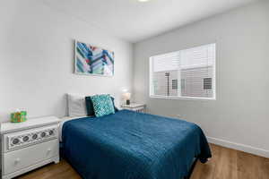 Bedroom featuring baseboards and wood finished floors