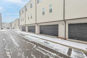 Exterior space with stucco siding and a garage