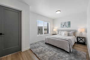 Bedroom featuring baseboards and wood finished floors