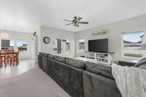 Living room with light wood-style flooring and ceiling fan