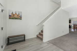 Stairway featuring baseboards and wood finished floors