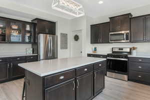 Kitchen featuring light countertops, light wood finished floors, and stainless steel appliances