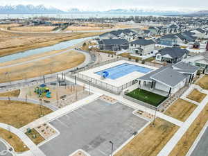 Birds eye view of community pool, parking, activity area, and trails