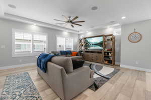 Premium living area with upgraded large plantation shutters, upgraded ceiling fan, canister lighting, and integrated ceiling speakers