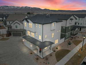 Aerial view at dusk featuring a mountain view and a residential view