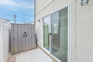 Sliding door, light fixture, street light, cement pad, gravel, vinyl fence