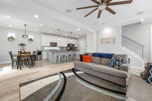 Premium living & kitchen area with upgraded counters, cabinets, upgraded ceiling fan, canister & designer lighting, and integrated ceiling speakers. View of st