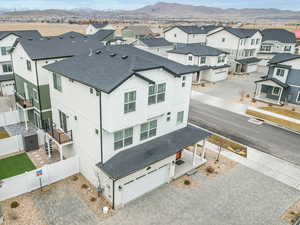 Bird's eye view looking at the front, balcony with upgraded spiral stairway, yard pavers/gravel