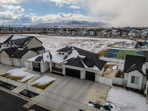 Snowy aerial view with a residential view and a mountain view