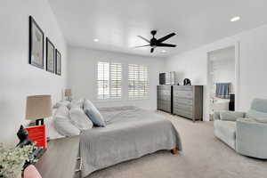 Primary Bedroom featuring light carpet, recessed lighting, connected bathroom, and a ceiling fan