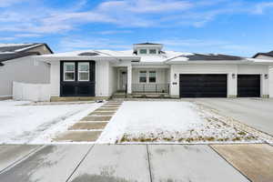 Prairie-style home with a gate, fence, a garage, and driveway