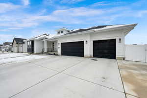 View of front of property featuring an attached garage and driveway